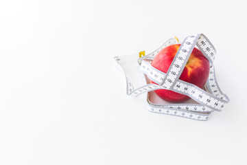 Red apple bind with tape measure for concept loss weight and diet healthy.
