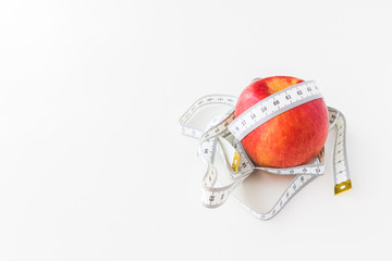 Red apple bind with tape measure for concept loss weight and diet healthy.