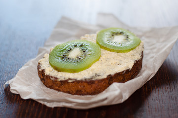 Snack, lunch, kiwi sandwich on pastry paper, side view