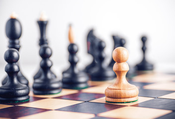 Chess board with wooden chess pieces on the table