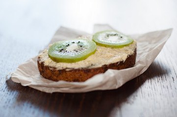 Snack, lunch, kiwi sandwich on pastry paper, side view