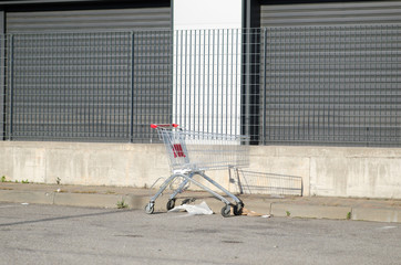 abandoned and empty shopping cart. Commercial crisis in a deserted industrial area, symbol of the suburbs of abandoned cities or in economic crisis.