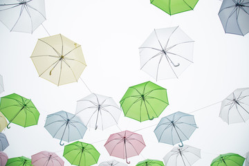 Fototapeta na wymiar Colorful umbrellas background. Colorful umbrellas in the sky