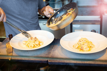 Chef brings in a plate seafood pasta