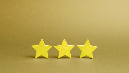 Three golden stars on a yellow background. Quality service, buyer choice. Success in business. The...