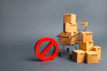 Cardboard boxes, supermarket trolley and red symbol NO. Embargo, trade wars. Restriction on the...