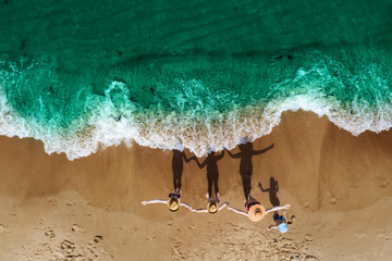 Aerial view of summer beach with ocean and family. Free space for your decoration and summer time 