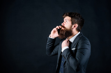 Businessman well groomed mature man hold smartphone. Guy call friend stand black background. Mobile call concept. Man formal suit call someone. Mobile call conversation. Mobile negotiations