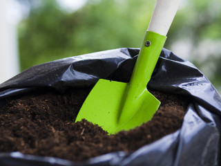 Shovel inside soil bag