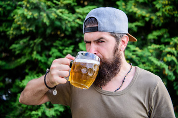 Hipster brutal bearded man hold mug cold fresh beer. Craft beer is young, urban and fashionable....