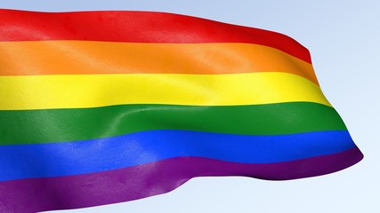 Gay pride rainbow flag waving against clean blue sky, symbol of tolerance and acceptance
