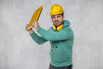 modern building supervisor keeps the computer in his hands, technology at work