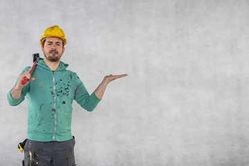construction worker with a hammer in hand, concept of construction and disassembly, renovation