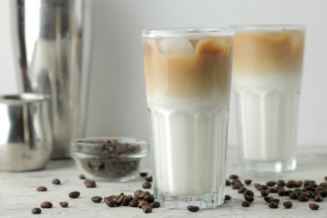 Ice latte or Iced coffee with milk and ice cubes in a glass beaker on a light background. refreshing drink. summer drink.