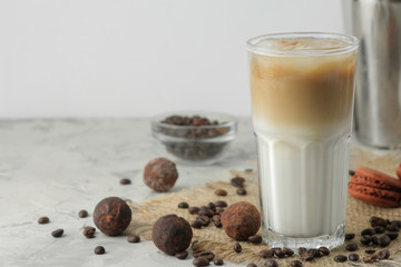 Ice latte or Iced coffee with milk and ice cubes in a glass beaker on a light background. refreshing drink. summer drink.