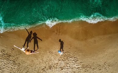 Aerial view of beach with family. Free space for your decoration and summer time. 