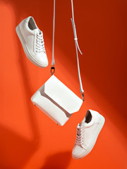 White sport shoes and small bag.