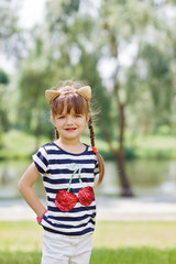 Fototapeta premium Young girl posing outdoors.Looking at camera