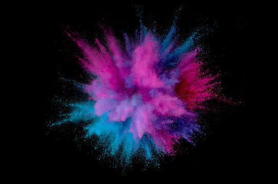 Colored powder explosion. Abstract closeup dust on backdrop. Colorful explode. Paint holi
