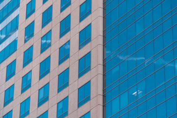 Obraz premium Closeup view on blue windows of modern office building. Commercial real estate business, office lease, rent concept