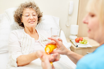 Bedridden senior woman gets medicine