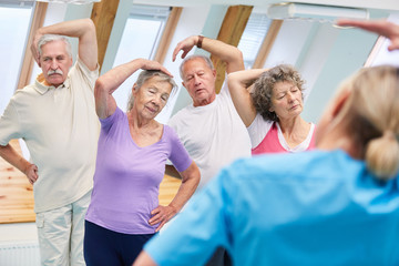 Group of seniors doing stretching exercise
