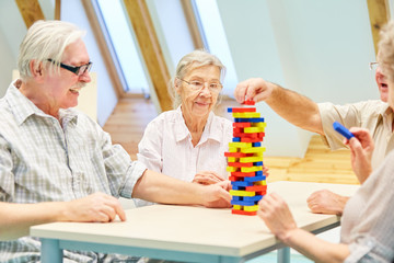 Seniors build a tower of building blocks