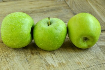 green apples on wooden table