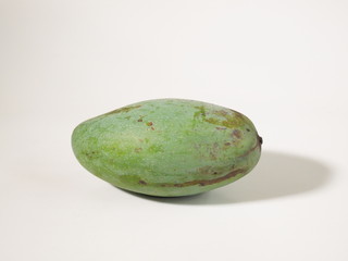 Green mango isolated on white background.