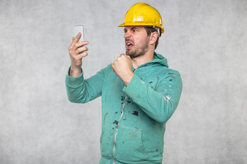 construction supervisor is shouting to a cell phone, copy space next to him