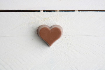 Chocolate bonbon with heart shape on white background..
