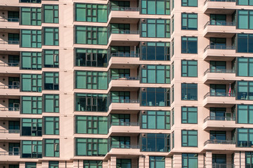 Fototapeta na wymiar San Diego, USA, 2018. Real estate, accommodation, rent, lease concept. Closeup view on balconies and windows of apartment home