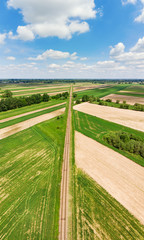Naklejka premium Railroad track amongst rural area aerial view