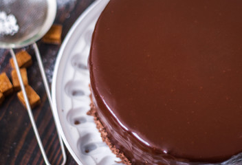 Glazed chocolate cake on the kitchen table.