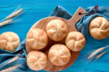 Crusty round bread rolls, known as Kaiser or Vienna rolls on linen towel
