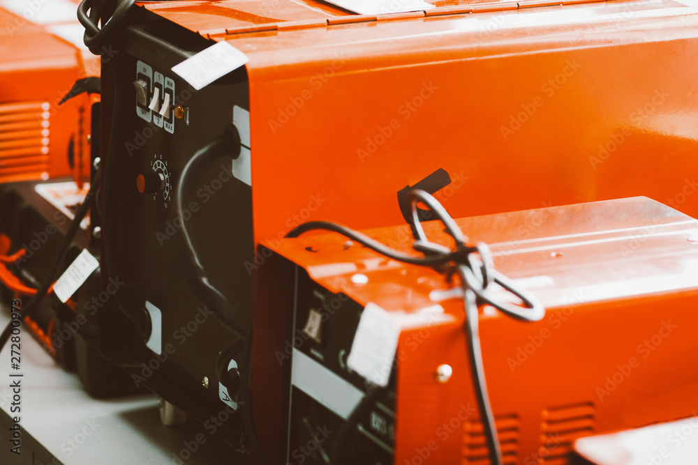 Wall mural Engineering equipment. Mechanic tool store. Closeup of new red welding machine display.