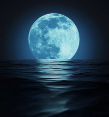 Naklejka na ściany i meble Big Blue Moon Reflected in Dark Wavy Water Surface