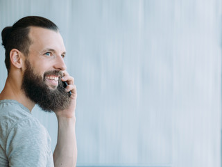 Successful professional career. Side view portrait of man talking on phone, smiling. Copy space.