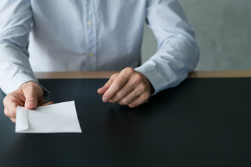 Business correspondence. Cropped shot of man passing white envelope. Copy space.