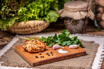 Burger cutlet with spices on a board