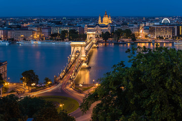 Fototapeta na wymiar Budapest urban scape with the Basilica, Devil's Wheel and the illuminated Chain Bridge across the Danube River by night.
