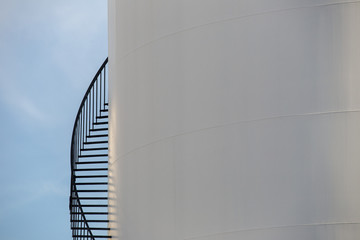 Crop of oil storage - oil terminal on the blue sky for background