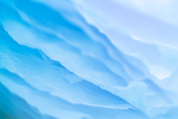 Obraz premium Closeup of blue paper layers stack abstract art background. Blur sea waves effect. Copy space.