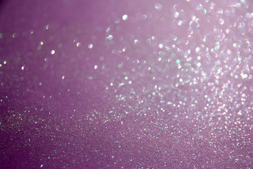 Purple sparkling shiny blurred background. Festive backdrop.