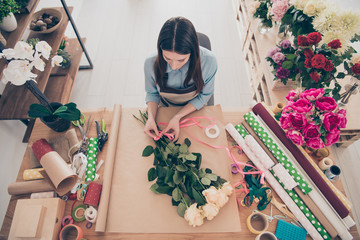 Top high above angle view photo of concentrated lady self-employed person hold hand touch environment natural look serious focused surprise holiday 8-march wedding table pink roses blue shirt hairdo - Powered by Adobe