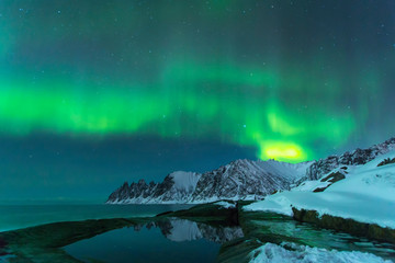 Northern lights with beautiful mountains by the ocean in Norway