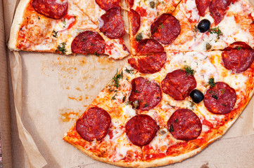 Italian pizza in a box close-up without one piece top view