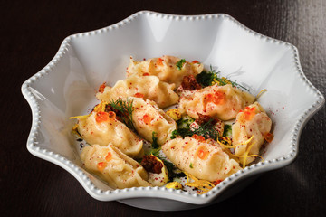 Dumplings, ravioli, dumplings with red caviar, close up