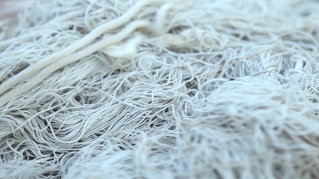 camera moves along the white old fishing net close-up. concept fishing