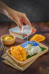 Mango sticky rice mix with coconut milk with wooden tray,Thai dessert